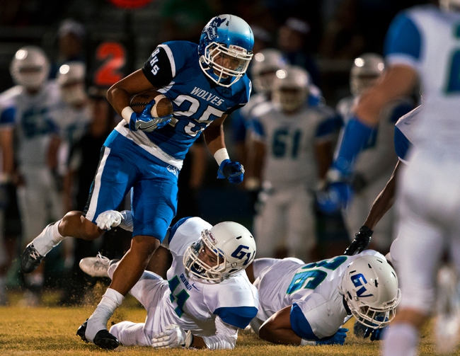Basic's Jordan Gallegos (25) breaks another Green Valley tackle attempt on a long run during the Henderson Bowl football game on Friday, Oct. 14, 2016.