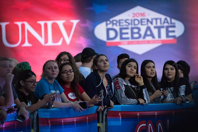 On-lookers watch a live segment of CNN's "Anderson Cooper 360" on the UNLV campus, Tuesday, Oct. 18, 2016, a day before the third and final presidential debate between Republican Donald Trump and Democrat Hillary Clinton.