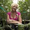 In this Wednesday, Oct. 12, 2016 photo, Christine Miller sits among some of the 250 marijuana plants on her farm near Benbow, Calif. Miller is concerned about the increased cost to operate her 250-plant farm if California voters approve Proposition 64, the Nov. 8 ballot initiative that would legalize the recreational use of marijuana. 
