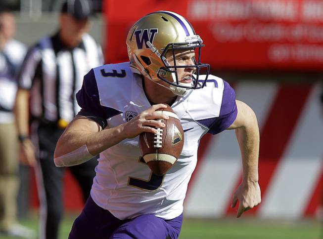 Washington quarterback Jake Browning (3) carries the ball as he looks downfield Saturday. 