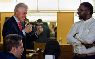 Former President Bill Clinton chats with some of the customers as he visits Hair Unlimited in the M.L.K. Plaza on Thursday, Nov. 3, 2016.