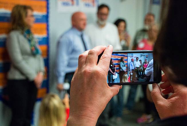 Former U.S. Congresswoman Gabrielle Giffords and her husband, Mark Kelly, speak to volunteers and proponents of the Question 1 ballot initiative in a south Las Vegas Valley office space on Saturday, Nov. 5, 2016. 