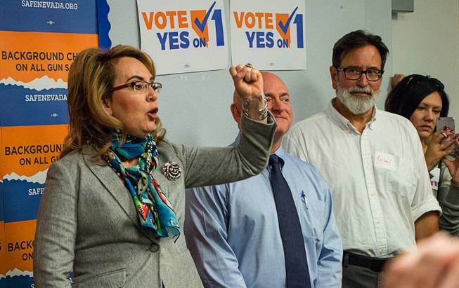 Former U.S. Congresswoman Gabrielle Giffords and her husband, Mark Kelly, speak to volunteers and proponents of the Question 1 ballot initiative in a south Las Vegas Valley office space on Saturday, Nov. 5, 2016. 