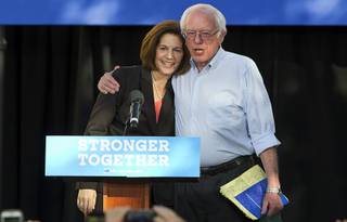 Nevada Senate candidate Catherine Cortez Masto is embraced by Vermont Senator Bernie Sanders at a rally at the College of Southern Nevada, Cheyenne Campus Sunday, Nov. 5, 2016.
