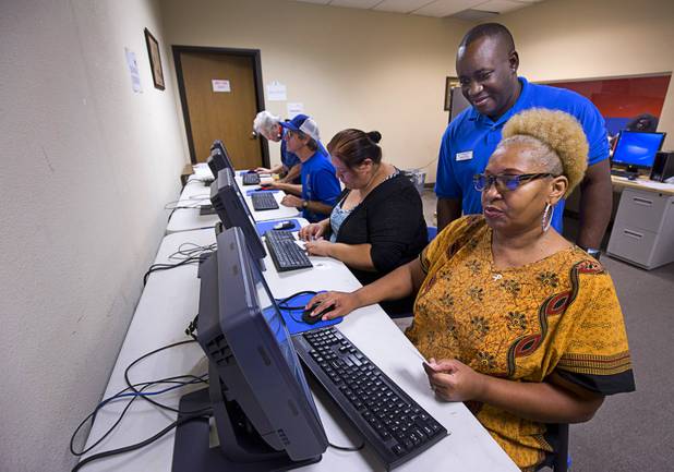 Derrick Felder, facilities and nutrition manger, watches as Margaret Coleman "shops" for food at Lutheran Social Services of Nevada (LSSN) Monday, Nov. 7, 2016. LSSN has installed DigiMart software, an online food pantry system.