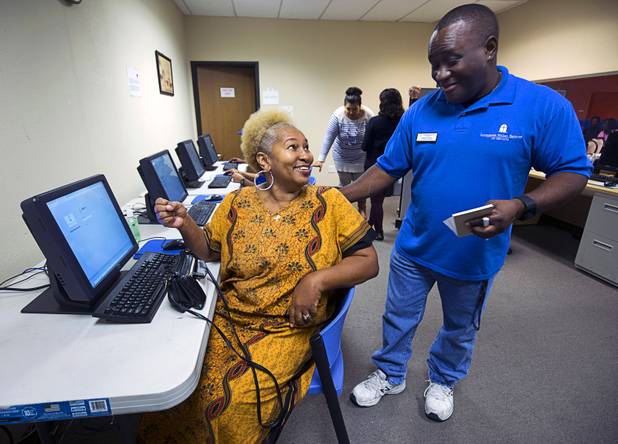 Margaret Coleman talks with Derrick Felder, facilities and nutrition manger, after placing a food order at Lutheran Social Services of Nevada (LSSN) Monday, Nov. 7, 2016. LSSN has installed DigiMart software, an online food pantry system.
