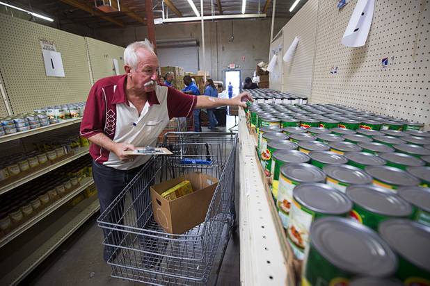 Volunteer Jess Parker fulfill's Margaret Coleman's food order at Lutheran Social Services of Nevada (LSSN) Monday, Nov. 7, 2016. LSSN has installed DigiMart software, an online food pantry system. Order "pickers'" fulfill most of the order, then the client just selects from meat, dairy and vegetables aisles.
