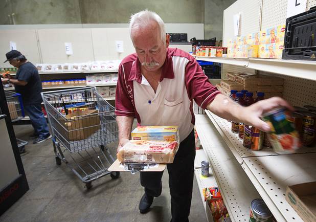 Volunteer Jess Parker fulfill's Margaret Coleman's food order at Lutheran Social Services of Nevada (LSSN) Monday, Nov. 7, 2016. LSSN has installed DigiMart software, an online food pantry system. Order "pickers'" fulfill most of the order, then the client just selects from meat, dairy and vegetables aisles.