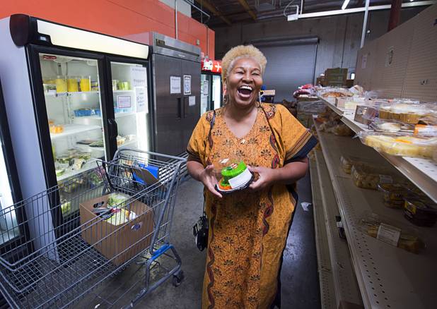 Margaret Coleman laughs as she selects a Halloween-themed cake at the Lutheran Social Services of Nevada (LSSN) food pantry Monday, Nov. 7, 2016. LSSN has installed DigiMart software, an online food pantry system. Order "pickers'" fulfill most of the order, then the client just selects from meat, dairy and vegetables aisles.