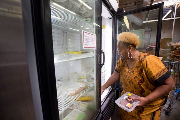 Margaret Coleman selects meat from a cooler at the Lutheran Social Services of Nevada (LSSN) food pantry Monday, Nov. 7, 2016. LSSN has installed DigiMart software, an online food pantry system. Order "pickers'" fulfill most of the order, then the client just selects from meat, dairy and vegetables aisles.