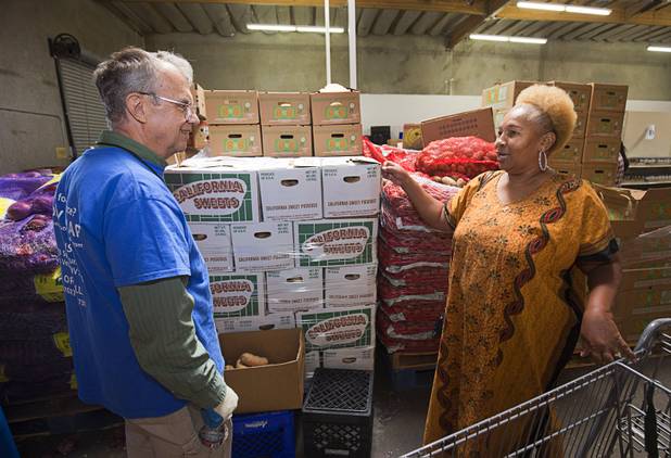 Margaret Coleman talks with volunteer Paul Clemmons at the Lutheran Social Services of Nevada (LSSN) food pantry Monday, Nov. 7, 2016. LSSN has installed DigiMart software, an online food pantry system. Order "pickers'" fulfill most of the order, then the client just selects from meat, dairy and vegetables aisles.