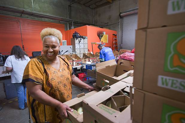 Margaret Coleman looks over fruit at the Lutheran Social Services of Nevada (LSSN) food pantry Monday, Nov. 7, 2016. LSSN has installed DigiMart software, an online food pantry system. Order "pickers'" fulfill most of the order, then the client just selects from meat, dairy and vegetables aisles.