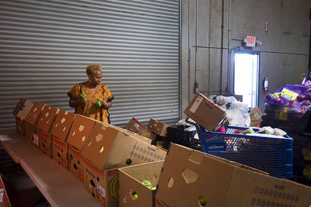 Margaret Coleman looks over a fruit and vegetable selection at the Lutheran Social Services of Nevada (LSSN) food pantry Monday, Nov. 7, 2016. LSSN has installed DigiMart software, an online food pantry system. Order "pickers'" fulfill most of the order, then the client just selects from meat, dairy and vegetables aisles.