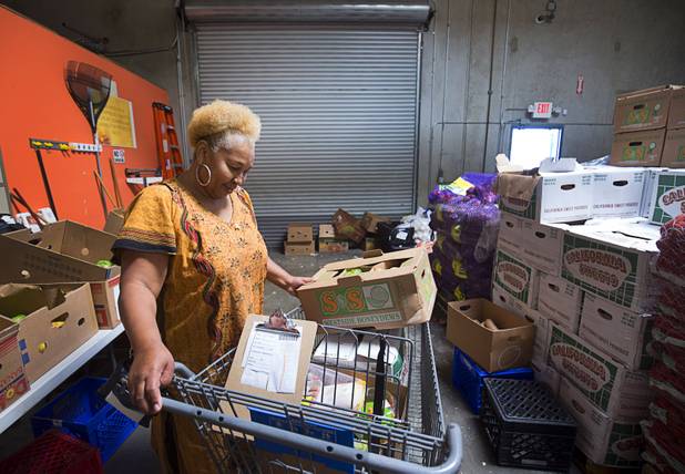 Margaret Coleman looks over her cart after "shopping" at the Lutheran Social Services of Nevada (LSSN) food pantry Monday, Nov. 7, 2016. LSSN has installed DigiMart software, an online food pantry system. Order "pickers'" fulfill most of the order, then the client just selects from meat, dairy and vegetables aisles.