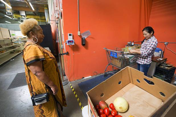 Ticket matcher Lisa Chu weigh's Margaret Coleman's cart at the Lutheran Social Services of Nevada (LSSN) food pantry Monday, Nov. 7, 2016. LSSN has installed DigiMart software, an online food pantry system.