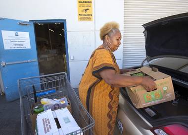 Margaret Coleman loads food into her car after “shopping” at the Lutheran Social Services of Nevada (LSSN) food pantry Monday, Nov. 7, 2016. LSSN has installed DigiMart software, an online food pantry system. Coleman and her husband needed some help after moving to Nevada from Los Angeles and having more moving expenses than they expected, she said.