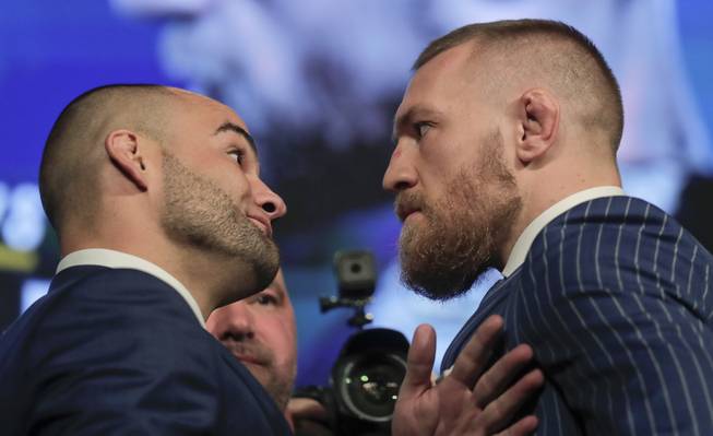 UFC lightweight champion Eddie Alvarez, left, and featherweight champion Connor McGregor, right, pose for photos during a new conference for UFC 205, Tuesday, Sept. 27, 2016, in New York. 