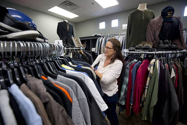 Karen Wikler organizes clothing in Betty's Boutique at Project 150 Thursday, Nov. 10, 2016. The nonprofit was created to help homeless, displaced and disadvantaged High School students.