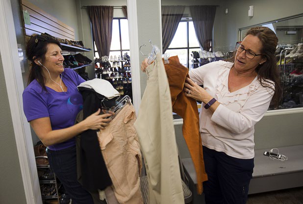 Renee Myers, left, and Karen Wikler organize clothing in Betty's Boutique at Project 150 Thursday, Nov. 10, 2016. The nonprofit was created to help homeless, displaced and disadvantaged High School students.