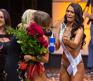 Miss Hooters International 2016 winner Sable Robert loses her new crown which Amberly Hall of Miami, Florida, is able to catch enjoys her victory at the Pearl Theater on Wednesday, July 13, 2016.  The Hooters 20th Anniversary International Swimsuit Pageant is where 80 girls from around the world now compete for the 2016 title.
