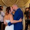 Bride Angelica Jannson kisses groom Jan Siarov as photographer Brian Hendricks (left) documents their wedding complete with a performance by Elvis at the Graceland Chapel on Thursday, August 25, 2016. The couple is from Gothenburg, Sweden, wanting an Elvis wedding performed by long-time impersonator Brendan Paul.