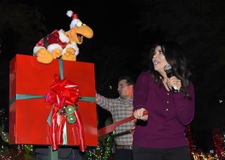 Radio host Mercedes Martinez flips a prop switch to turn on the lights during the annual cactus lighting ceremony at Ethel M Chocolates Tuesday, Nov. 15, 2016 in Henderson.