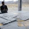 In this April 13, 2016, file photo, Gov. Brian Sandoval looks at a model for a Faraday Future factory in North Las Vegas. 
