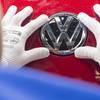In this Sept. 6, 2016, file photo, a worker checks the Volkswagen sign on a Golf car during the so-called 'Open Door Day' to celebrate the 25th anniversary of the German manufacturer Volkswagen Sachsen in Zwickau, eastern Germany.