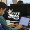 In this Sept. 9, 2015, file photo, Bear Duker, a marketing manager for strategic partnerships at DraftKings, works at his computer at the company headquarters in Boston.