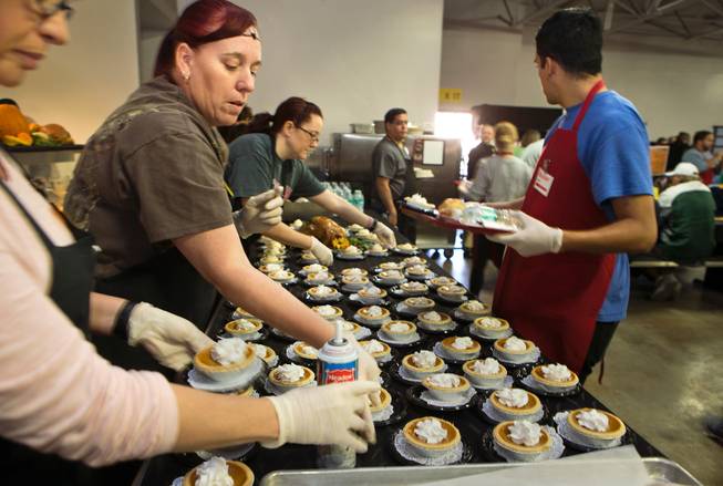 Volunteers ready more, little pumpkin pies as Catholic Charities of Southern Nevada serves their 51st consecutive free Thanksgiving meal to roughly 1,000 homeless and vulnerable men, women and children on Thursday, Nov. 24, 2016.