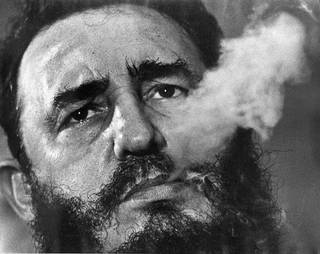 In this March 1985 file photo, Cuban Prime Minister Fidel Castro exhales cigar smoke during an interview at his presidential palace in Havana, Cuba. Castro, a Havana attorney who fought for the poor, overthrew dictator Fulgencio Batista's government on Jan. 1, 1959. 