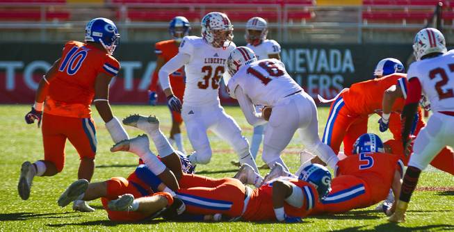 Liberty's kicker Damahny Whittle (18) plows on for a possible first down on a blown punt over Bishop Gorman's defense during their high school football state championship game at Sam Boyd Stadium on Saturday, Dec. 3, 2016.
