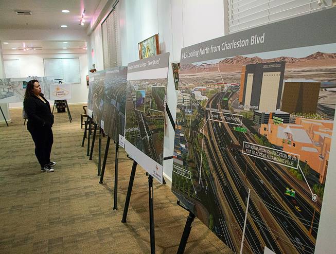 A woman looks through Project Neon renderings during a Nevada Department of Transportation public meeting at the Historic Fifth Street School Wednesday, Dec. 7, 2016.