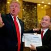 President-elect Donald Trump, left, accompanied by SoftBank CEO Masayoshi Son, speaks to members of the media Tuesday, Dec. 6, 2016, at Trump Tower in New York. Trump talked up the Japanese mogul, who after meeting with the president-elect in New York, spotlighted his plan to invest $50 billion and create 50,000 jobs.