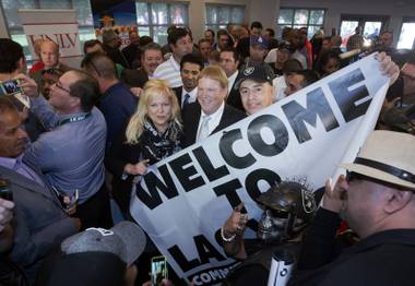 Raiders owner Mark Davis poses with Raiders fans during a bill signing ceremony at UNLV Monday, Oct. 17, 2016. The bill will increase hotel room tax to help finance a $1.9 billion stadium. 