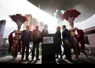 Representatives from Las Vegas Events, the Las Vegas Convention and Visitors Authority, Fireworks by Grucci and local politicians watch a brief fireworks display during a news conference at the Fashion Show Mall Thursday, Dec. 15, 2016.  Details for the annual New Year's Eve celebrations in Las Vegas were unveiled at the news conference.