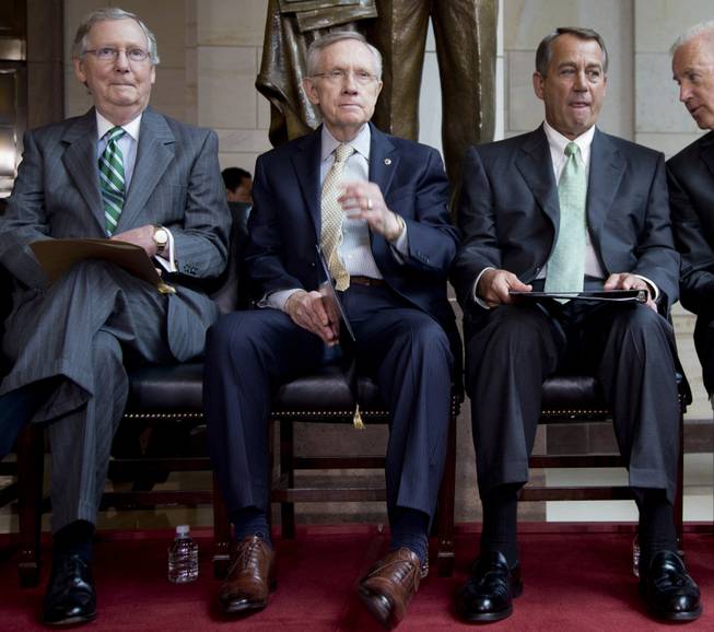In this 2013 photo, Senate Minority Leader Mitch McConnell, Senate Majority Leader Harry Reid, House Speaker John Boehner and Vice President Joe Biden participate in a ceremony on Capitol Hill.