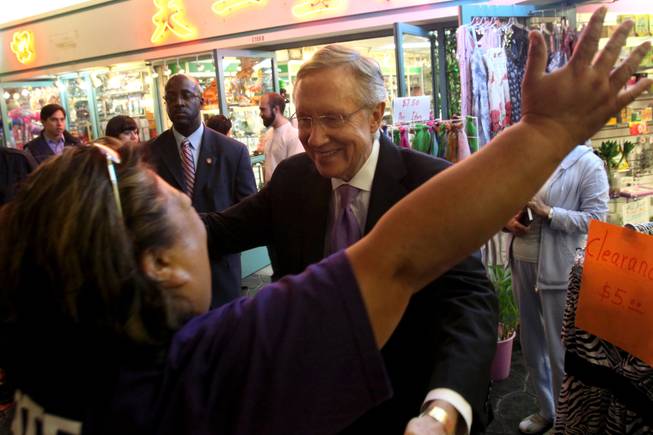 Reid gets a hug from Ipo Naihe as he campaigns in Chinatown in Las Vegas in 2010.
