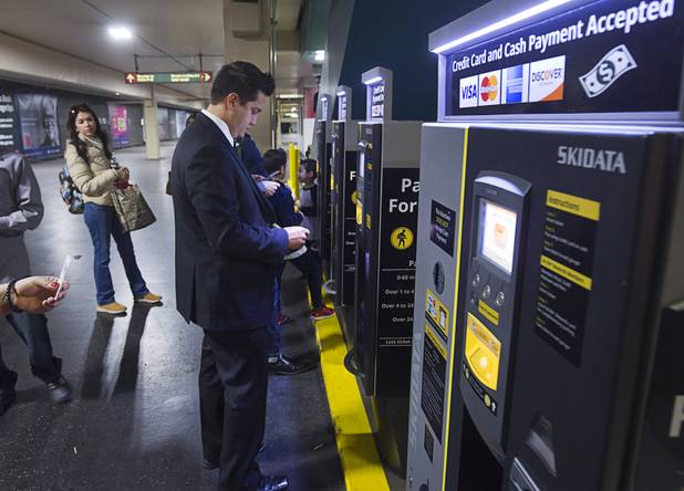 People pay for parking at the MGM Grand parking garage Tuesday, Dec. 20, 2016.