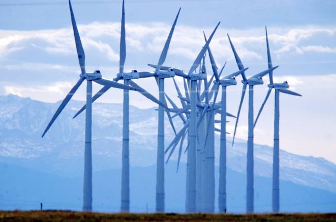 Turbines spin in the wind south of Cheyenne, Wyo. A 728-mile power line, approved Dec. 13, will move wind energy from Wyoming to Southern Nevada.