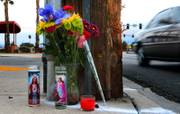 Flowers are left near the spot where North Las Vegas police detective Chad Parque was critically injured in a Friday afternoon crash along N. Martin Luther King Boulevard north of W. Carey Ave on Saturday, Jan. 7, 2017.  He passed away early this morning from the related injuries.