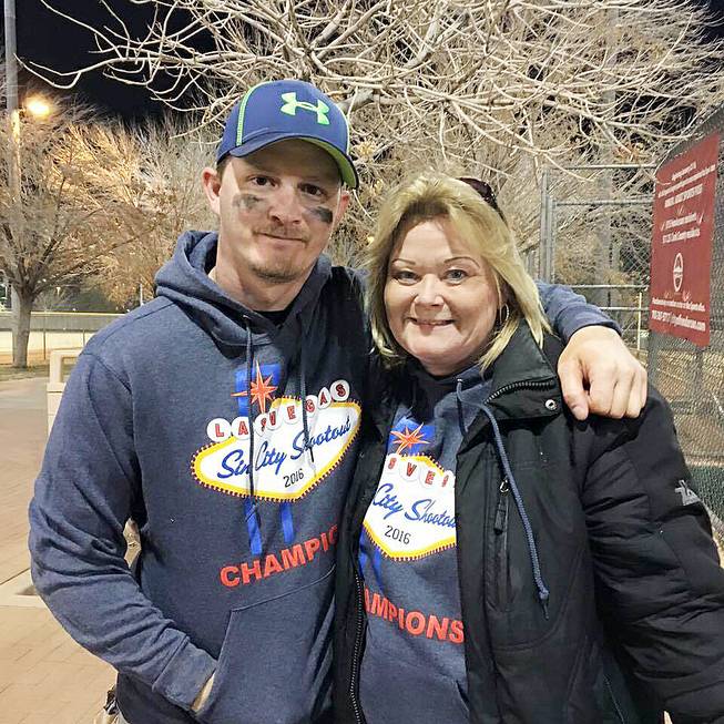 Shawn Dunlap and Jackie Pass pose with their gift sweatshirts after the Lightning won the Sin City Shootout's C division championship in 2016.