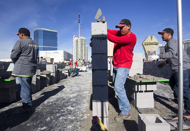 Adrian Tena, of G&G Enterprises in Phoenix, Ariz., competes  in the "Fastest Trowel on the Block" competition during the World of Concrete convention at the Las Vegas Convention Center Wednesday, Jan. 18, 2017. The event is similar to the annual Bricklayer 500 but with cinderblocks.