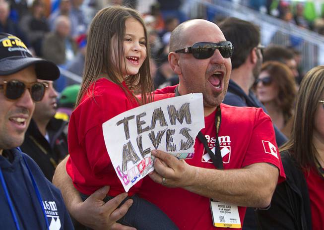 Michael Alves and his daughter Maddy, 5, of Hamilton, Ontario, Canada cheer for mason Mario Alves as he competes in the 15th Anniversary Spec Mix Bricklayer 500 during the World of Concrete convention at the Las Vegas Convention Center Wednesday, Jan. 18, 2017. Top masons from across North America, and one from England, competed to build the best brick wall in one hour.