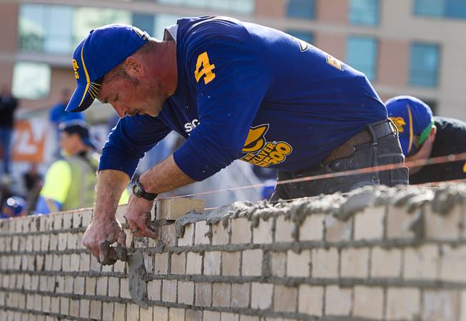 Cole Stamper, of Mason Structure in Lexington, Ky., competes in the 15th Anniversary Spec Mix Bricklayer 500 during the World of Concrete convention at the Las Vegas Convention Center Wednesday, Jan. 18, 2017. Top masons from across North America, and one from England, competed to build the best brick wall in one hour.
