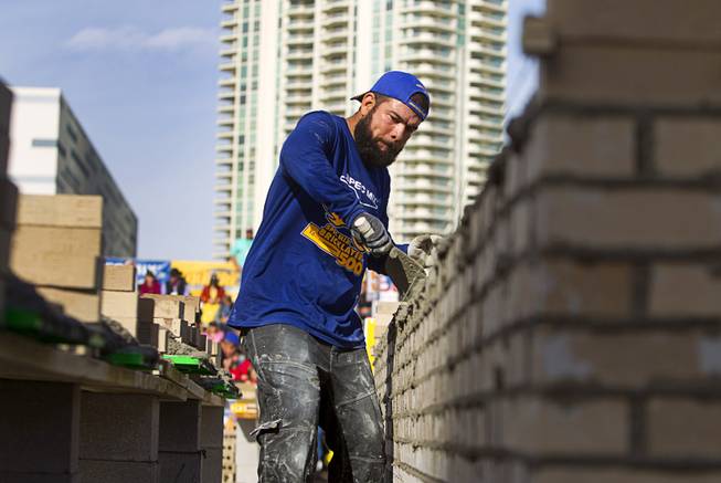 David Puga Arce, of Stone Cold Mason in Phoenix, Ariz., competes in the 15th Anniversary Spec Mix Bricklayer 500 during the World of Concrete convention at the Las Vegas Convention Center Wednesday, Jan. 18, 2017. Top masons from across North America, and one from England, competed to build the best brick wall in one hour.