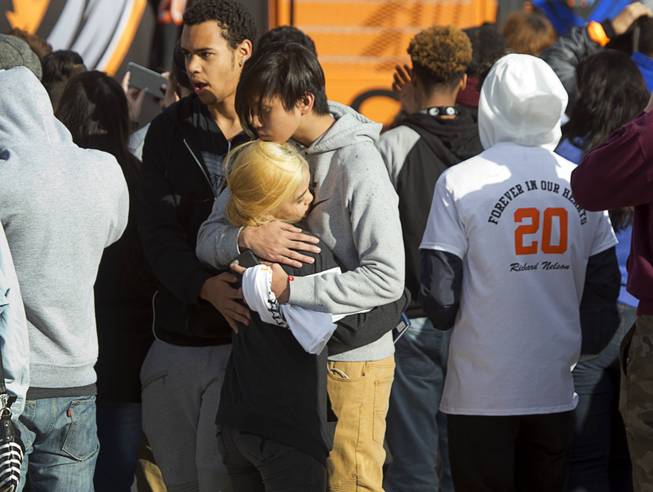 People embrace during a memorial service for former Chaparral High athlete Richard Nelson at the school Thursday, Jan. 19, 2017. Nelson was shot and killed Saturday while attempting to break up a fight involving his sister.