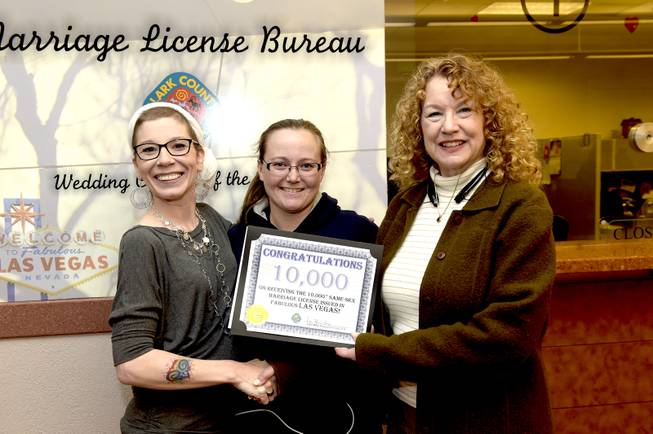 Clark County Clerk Lynn Goya presents a certificate commemorating for the 10,000th same-sex marriage license issued to Amanda Falzone and Jennifer Dickerson of Colorado Springs, Colorado at the Clark County Courthouse in downtown Las Vegas. In celebration of this milestone, local businesses have donated wedding presents for the 10,000th same-sex couple  including a two-night stay and dinner at Mandalay Bay, passes to the High Roller observation wheel at The LINQ Promenade, flowers, professional photographs and a wedding ceremony.  Friday, January 20, 2017. CREDIT: Glenn Pinkerton/Las Vegas News Bureau