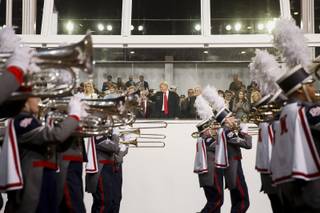 President Donald Trump watches as a marching band passes the reviewing stand during his inaugural parade on Pennsylvania Ave. outside the White House in Washington, Friday, Jan. 20, 2017. (AP Photo/Andrew Harnik)