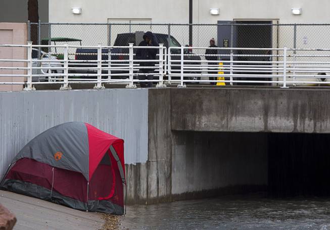 A tent is shown by a storm culvert near the Hard Rock Sunday, Jan. 22, 2017. Three people were reported washed away by stormwater runoff but were rescued downstream by the Clark County Fire Department.